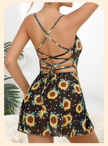 Detail of sunflower print dress featuring criss-cross back straps and waist tie bow