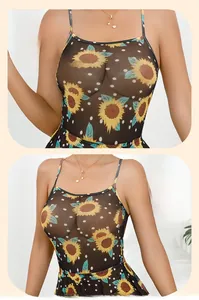 Detail of sheer black mesh dress featuring sunflower print and white polka dots