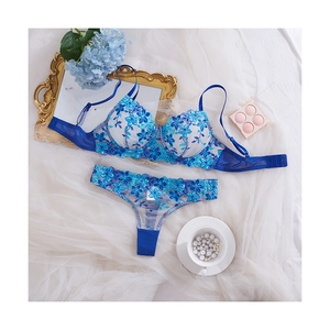 Elegant bright blue floral lace lingerie set with push-up bra and thong on white silk