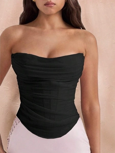 Detail of black corset top featuring fishbone structure and pleated mesh fabric texture