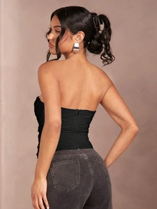 Detail shot of black strapless corset top with pleated texture and back zipper closure