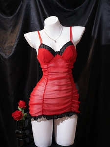 Detail of red glitter mesh nightgown featuring black lace trim and ruched design