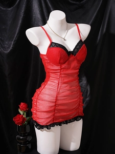 Detail of red mesh nightgown featuring shimmering sequins and black lace trim accents