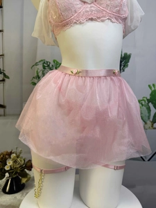 Detail of pink mesh tutu skirt with delicate rose accents and gold chain garters