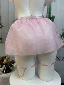 Detail of pink mesh mini skirt with metallic buckle and matching chain leg rings
