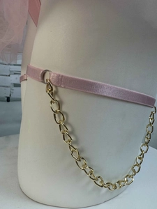 Detailed view of pink elastic leg garter with chunky gold metal chain links and rings