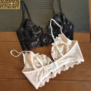 Detail of floral embroidery and mesh lace on sexy deep V-neck bras in black and beige