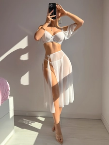 Detail of white mesh bra and high-waist chiffon skirt with side slits for vacation