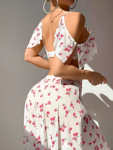 Detail of white mesh lingerie set with red rose floral print and silver metal ring accents