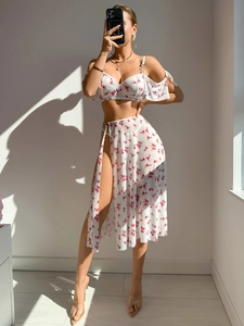 Detail of high-slit floral mesh skirt and ruffle top with golden ring hardware