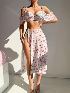 Detail of white floral beach set featuring metal ring buckle and high slit mesh skirt