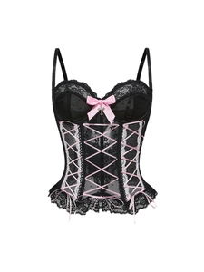 Detail of black lace corset featuring pink satin ribbons and a silver cross pendant