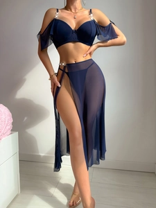 Detail of dark blue mesh lingerie set with bow accents and metallic ring connectors