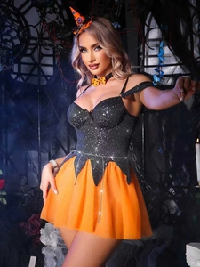 Detail of Halloween witch costume with black sequin top and orange pumpkin tulle skirt