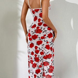 Back view of a white floral maxi dress with red rose print and thin straps on a model
