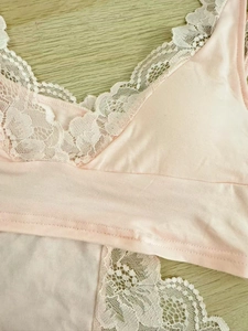 Close-up of pink modal lace bra featuring intricate floral embroidery and soft fabric texture