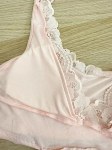 Close-up of light pink modal nightdress featuring delicate white lace trim details
