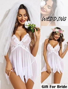 Detailed bridal lace nightgown with sheer mesh, decorative bows and wedding accessories