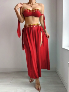 Detail of red belly dance outfit with gold leaf tassels and sequins on sheer fabric