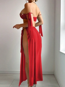 Detail of red exotic two-piece performance costume featuring golden gems and side slit