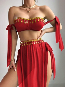 Detail of red mesh bra set with gold fringe tassels and yellow droplet pendants
