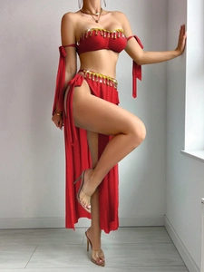 Detail of red belly dance outfit with golden sequins and tassel fringe embroidery