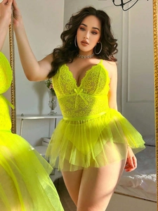 Detail of neon yellow floral lace bodysuit with layered mesh tutu skirt for women
