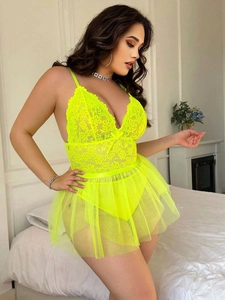 Detail of neon lace bodysuit with sheer mesh skirt featuring floral patterns and deep V-neck