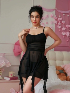 Detail of sheer black mesh lingerie set featuring ruffled hem and delicate spaghetti straps