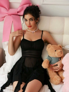 Detail of black mesh babydoll lingerie with pleated bust and sheer hemline fabric