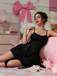 Detail of sheer black mesh lingerie dress with layered ruffles and heart choker accessory