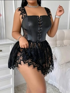 Detail of black faux leather corset with eyelash lace trim and intricate floral pattern