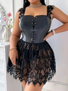 Close-up of black faux leather corset dress with lace trim and front lace-up detailing