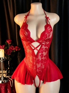 Detail of red lace teddy lingerie with deep V-neck, bow accents and floral patterns