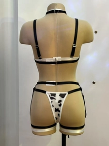Detailed back view of cow print lingerie set with adjustable straps and buckles