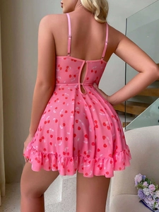Detail view of pink heart print lingerie dress with ruffled hem and open back straps