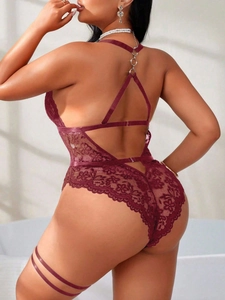 Detailed back view of burgundy lace bodysuit featuring crisscross straps and metal rings