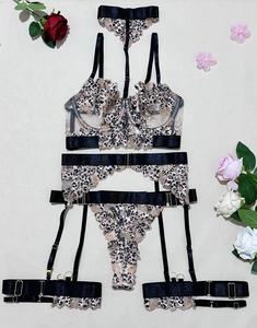 Flat lay of leopard print lace lingerie set with garters and mesh detailing