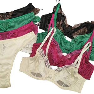 Lace-trimmed satin lingerie set with underwire bras and panties in multiple colors