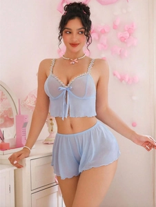 Detail of light blue mesh sleepwear set featuring pink floral lace and bow accents