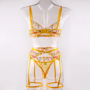 Detailed embroidery on yellow mesh bra with floral patterns and adjustable garter straps