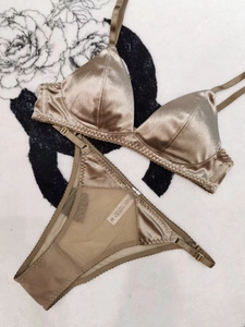 Detail shot of champagne silk triangle bra and mesh panty set with adjustable straps