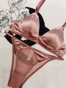 Detail view of rose gold satin lingerie set with triangle cups and sheer mesh fabric