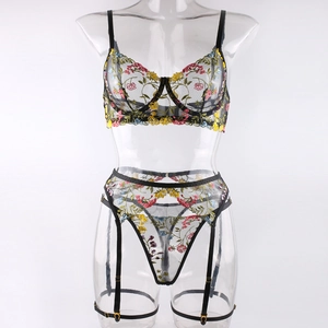 Detailed view of floral embroidery on black mesh lingerie set with garter belt
