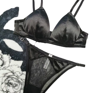 Elegant black satin triangle bra set with sheer mesh panel panties and thin straps
