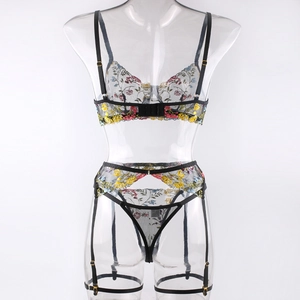 Close-up of colorful floral embroidery on black sheer mesh lingerie set with garter
