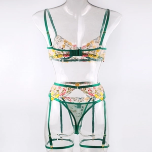 Detailed embroidery on green mesh lingerie set with floral patterns and garters