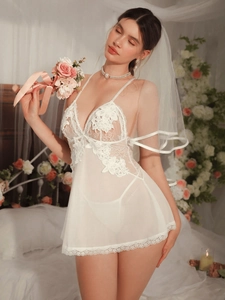 Detail of white lace patchwork mesh nightdress set with delicate floral applique