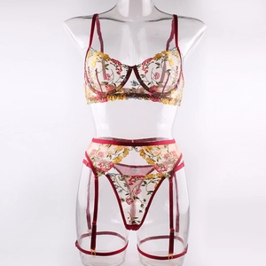 Close-up of floral embroidery on sexy sheer mesh bra and garter belt with steel wire