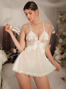 Detailed view of floral embroidery lace and sheer tulle on a white bridal nightdress